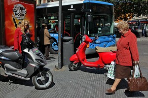 FEMMES ET SCOOTERS A L'ARRET DE BUS, PLAZA CALLAO, MADRID, ESPAGNE 